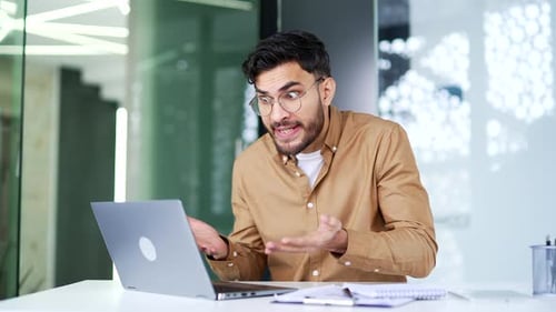 Frustrated Man Arguing During Video Conference Call