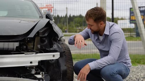 Adult Upset Driver Man in Front of Automobile Crash Car Collision Accident in City Road