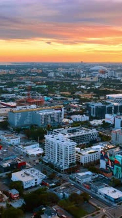 Amazing colorful sky over the vast cityscape. Aerial view of Miami, Florida, USA at sunset.