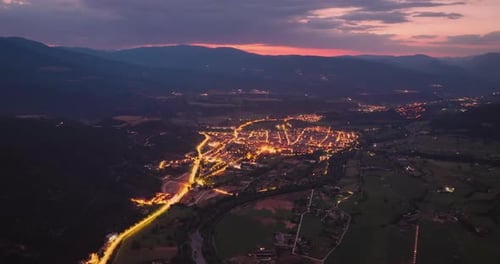 Hyperlapse Shot of a City in the Mountains at Night Cars Move Through the City in the Light of