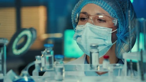 Scientist Examining Vials in a Laboratory Setting