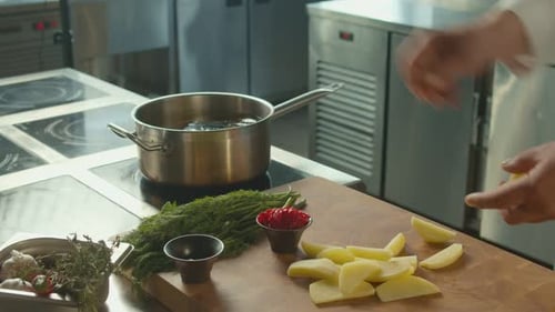 Chef Preparing Potatoes in Commercial Kitchen