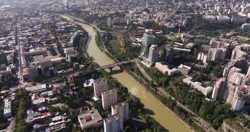 High Aerial View Above Kura River in Downtown Tbilisi, Georgia. Modern Skyscraper Buildings