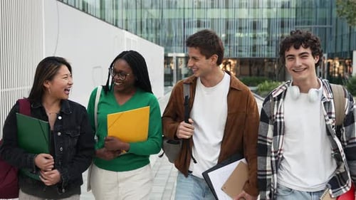 Happy Student Friends Walking on University Campus Outdoors After Classes Asian African American