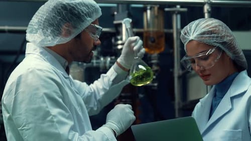 Two Scientist in Professional Uniform Working in Curative Laboratory