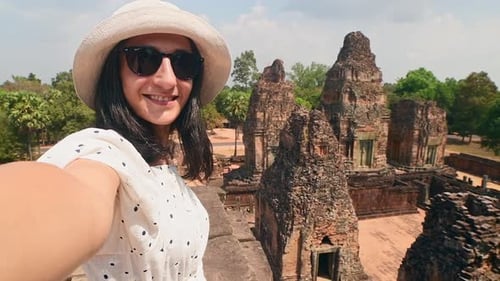 Tourist Taking Selfie With Angkor Wat Temples