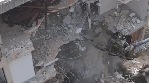 Aerial video of the demolition of an old building and urban renewal in Israel.