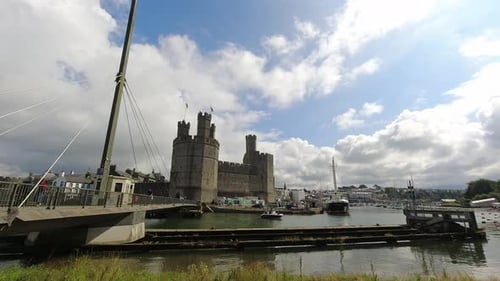 Timelapse historic Caernarfon castle swinging river bridge tourist town landmark