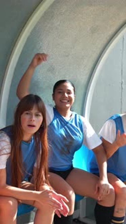 Female Soccer Players Cheering and Celebrating a Goal From the Bench