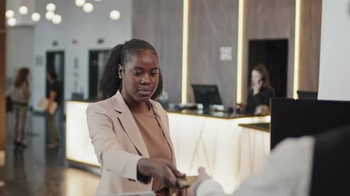 Black Woman Checking In At Hotel