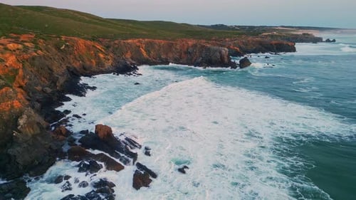 Aerial View of Rugged Coastline at Sunset