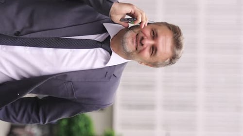 Happy Adult Man in Suit Talking on the Mobile Phone in the City Real Time Concept