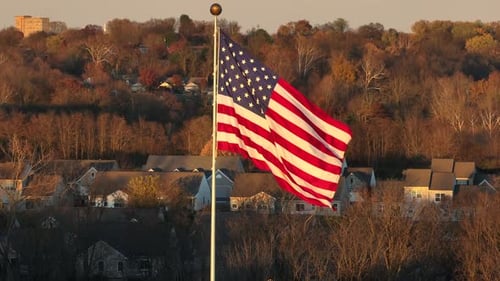 American Flag Waving over Suburban Neighborhood