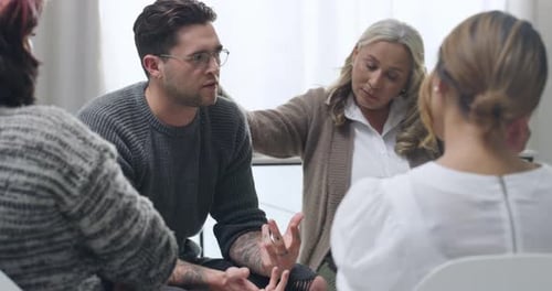 Group Therapy Session with People Sitting in Circle