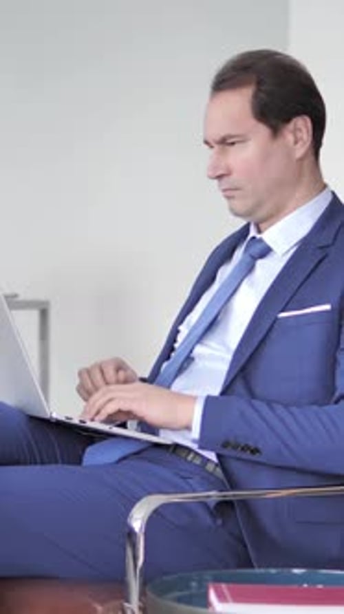 Professional Man Working On Laptop In Modern Office