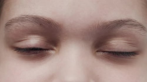 Macro Shot of Young Person Opening Eyes