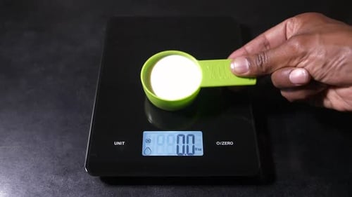 Kitchen Food Scales LCD Displays a quarter Cup of Milk as 2 ounces