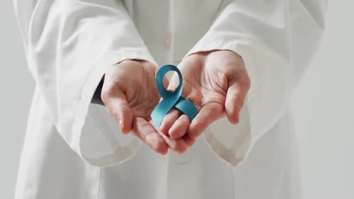 doctor's hands holding a ribbon