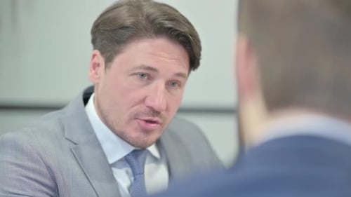 Close Up of Businessman Talking with Partner in Office