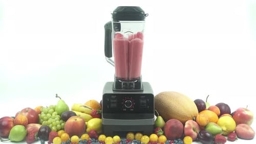 Blender Creates Fruit Smoothie Surrounded by Fresh Fruit