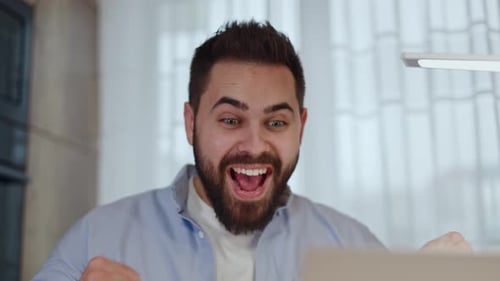 Man Celebrating Success at His Computer