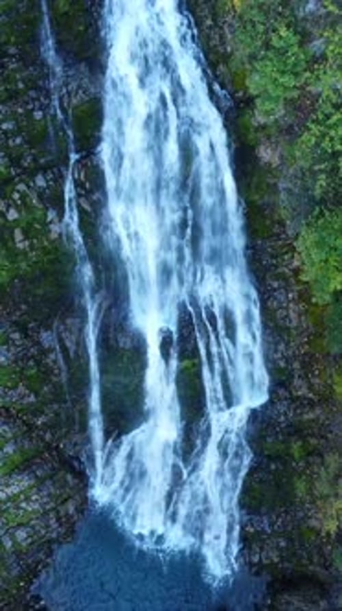 Aerial View of Waterfall Flowing Over Rocks