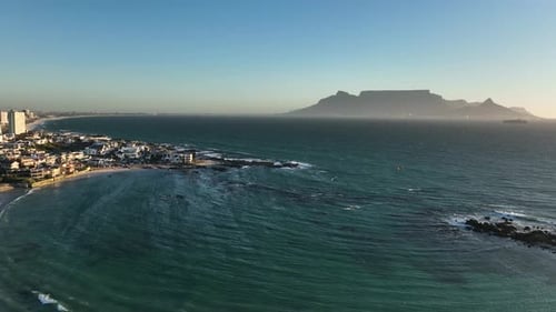 Aerial view of flat Table mountain seen from Cape Towns Big Bay in sunset glow