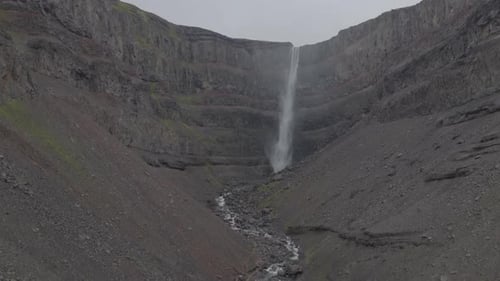 Majestic Waterfall Cascading Down Rocky Cliffside in Iceland