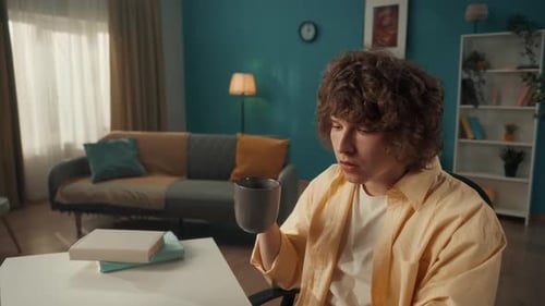 Young Adult Working at Computer, Drinking Coffee