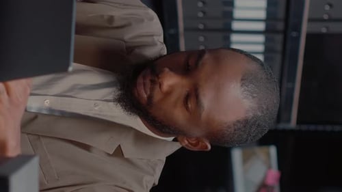 Man Drinks Coffee at Dark Workplace