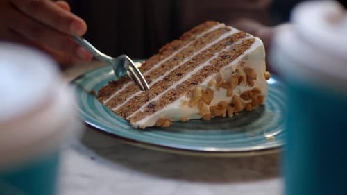 Close-up of Fork Taking Bite of Carrot Cake