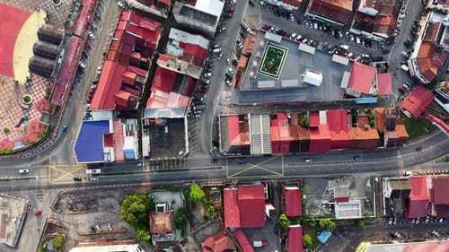 Aerial shot captures vibrant red roofs and busy streets