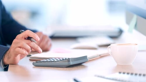 Accountant and trader calculating finances in an office while investing and saving money