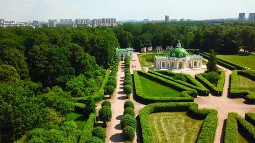 Top view of people walking on territory of palace garden. Creative. Beautiful road of palace garden