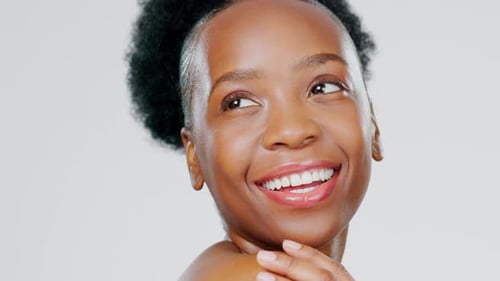 Skincare, happy and portrait of a black woman with a glow isolated on a grey studio background