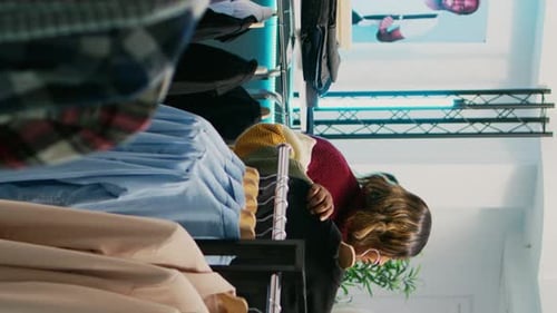 Vertical Video Store Assistant Helping African American Client with Clothes