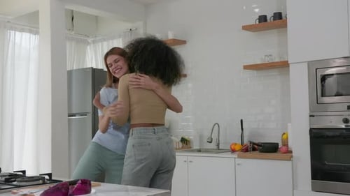 Two Women Dancing and Hugging in Kitchen
