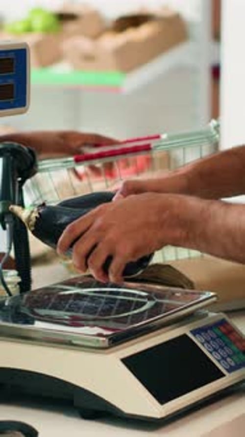 Weighing Eggplant and Pepper at the Grocery Store