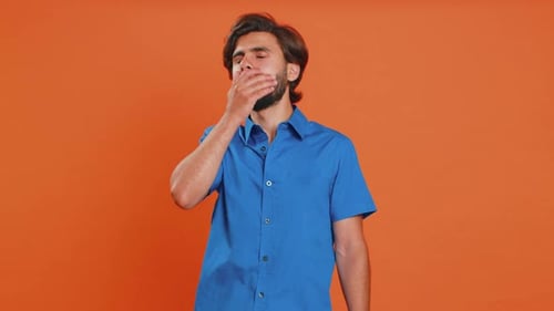 Tired Man Yawns and Pretends to Sleep