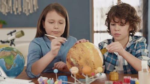 Children Paint Solar System Model Together at Home