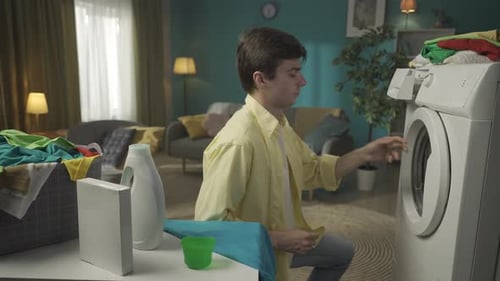 Young Adult Doing Laundry at Home