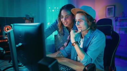 Young Adults Working Together at a Computer Late Night
