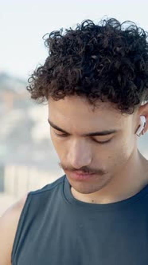 Fitness, man and getting ready with earphones in city for cardio workout
