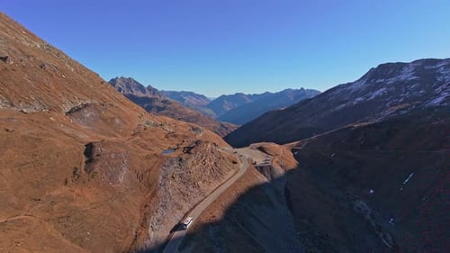 Furka Pass from the air, bathed in sunlight in the Swiss Alps.