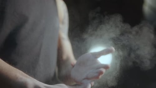 Person Rubs Hands Together Making White Powder Cloud