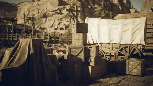 Rustic Wooden Crates and a Covered Wagon in a Desert Landscape at Dusk