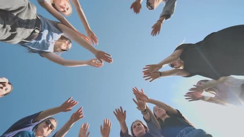 Cheerful Girlfriends Make Their Hands Together on a Sunny Day
