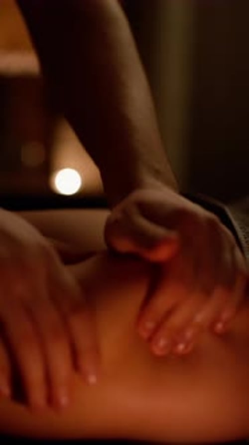 Calming Leg Massage Unfolds in a Softly Lit Spa Creating a Cozy Ambiance The Application of Oil