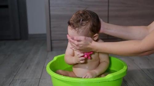 Loving Parent Giving Baby a Bath at Home