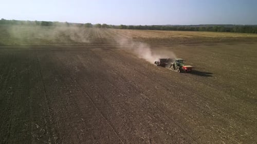 Tractor on the field seeding wheat